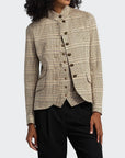 Woman wearing a plaid blazer with a white background