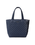 Navy quilted handbag on a light gray background