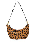 Leopard print handbag with a black strap on a white background