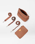 top view of the mz wallace Crosby Ella Crossbody Terracotta on a grey background with the straps laid out