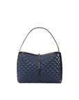 Blue quilted handbag on a light gray background
