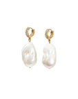 Pair of pearl earrings with gold hoop clasps on a white background