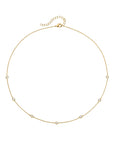 Gold necklace with small beads on a white background