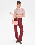 model holding the clare v Petit Moyen Messenger Puffy Woven Blush