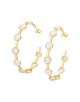 Gold hoop earrings with white stones on a white background