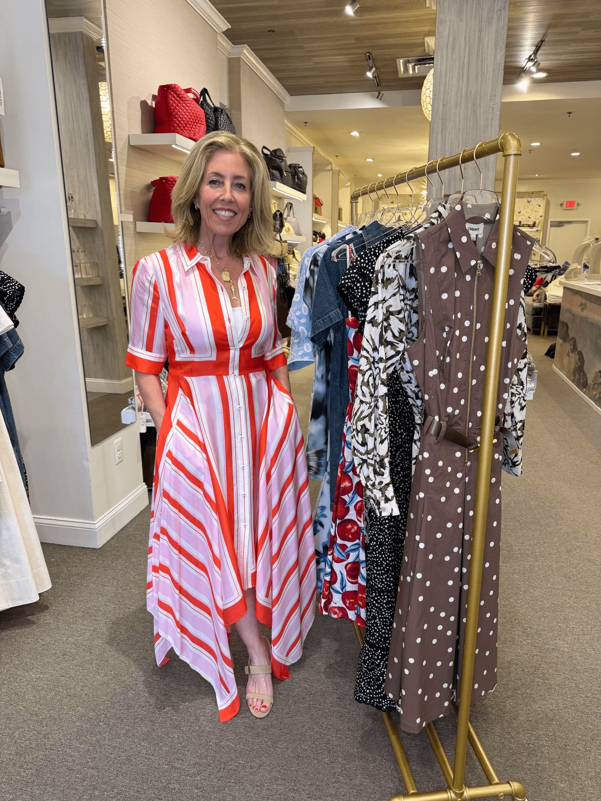 model wearing a spring color outfit: a cheerful Abrielle handkerchief midi dress in bright tulip colors, and beige platform heels