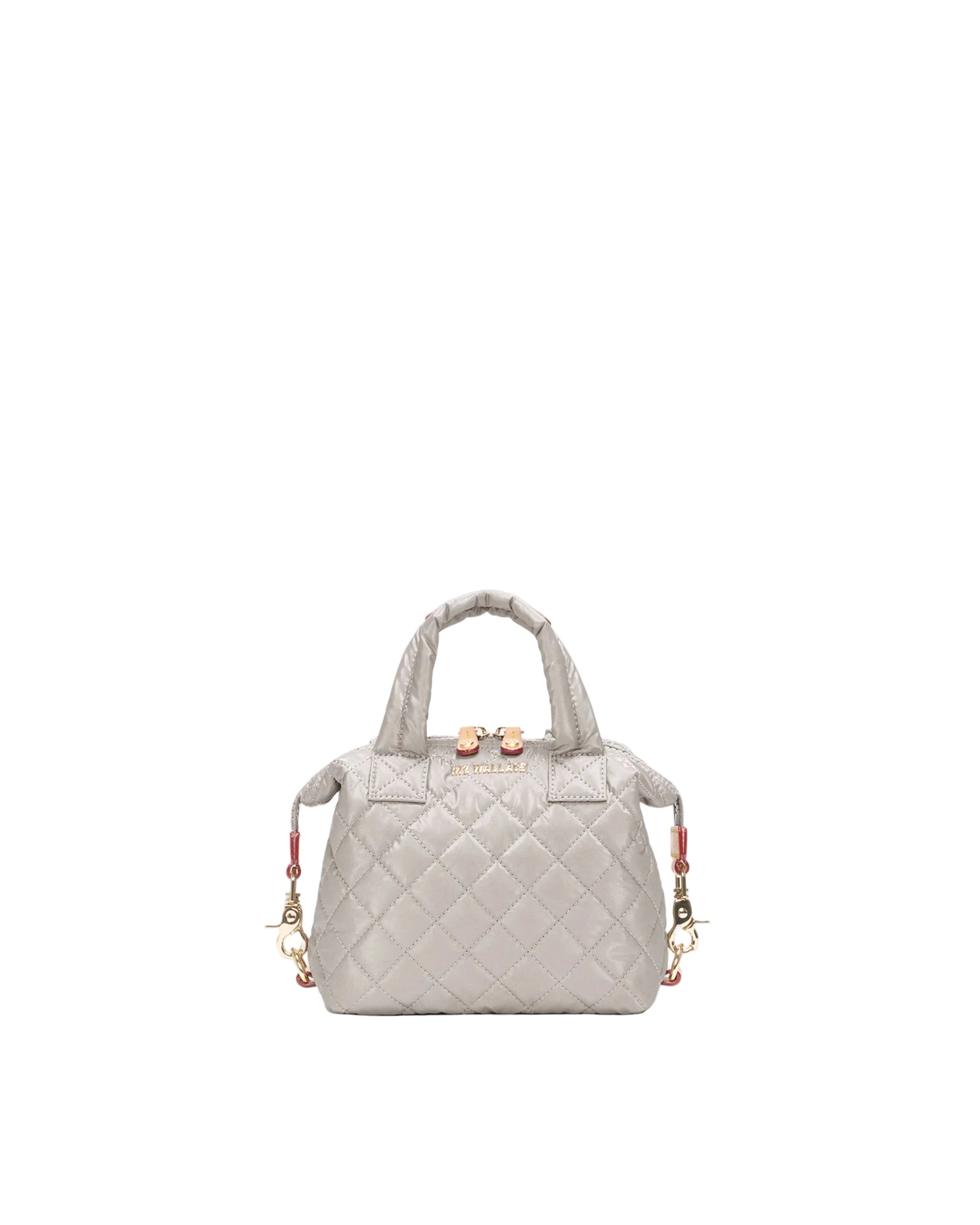 Quilted handbag with gold accents on a light gray background