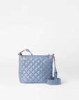 back view of the mz wallace Metro Scout Crossbody Deluxe Stone Blue on a grey background