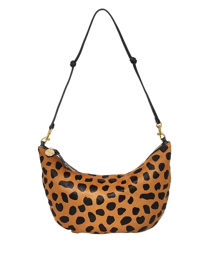 Leopard print handbag with a black strap on a white background