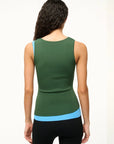 back view of staud Hermosa Tank Jungle/Sky on a brunette model also wearing black leggings in front of a beige background