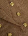 close of up the buttons on the  l'agence Brooke double breasted crop blazer in latte/gold 