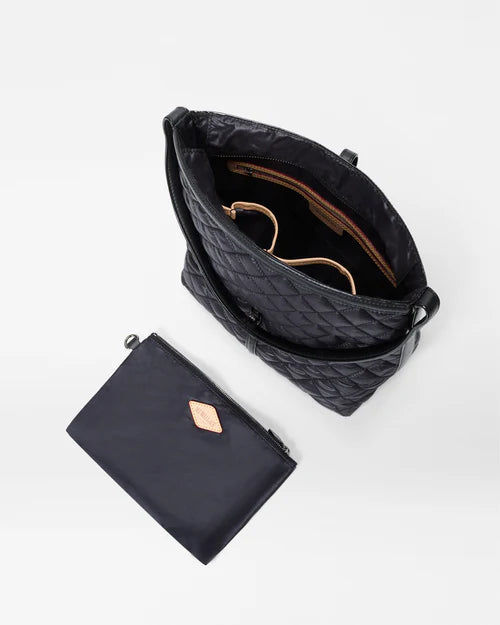 top view of the mz wallace Small Astor Hobo Black on a grey background with the interior pouch laid out