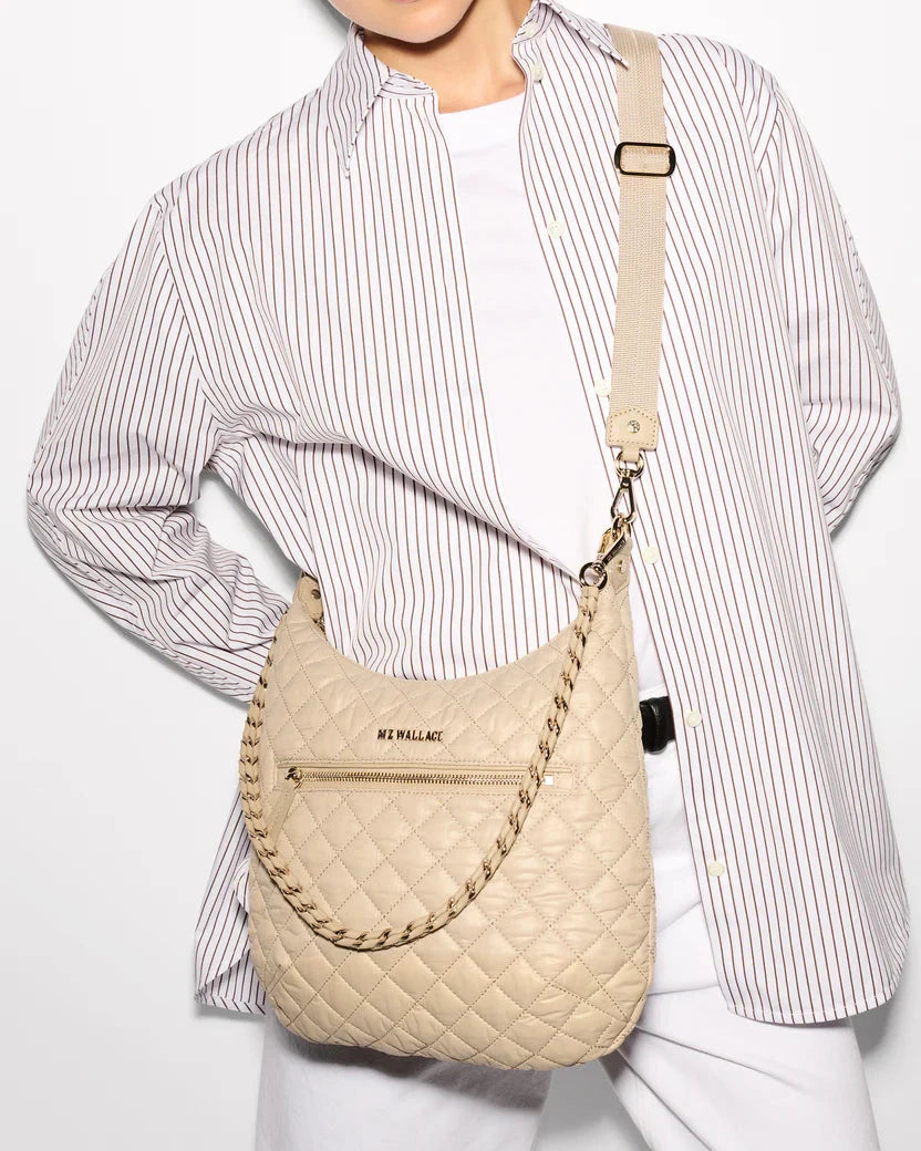 MZ Wallace Crosby Sienna Buff Hobo & Shoulder worn by model wearing striped button down and white jeans, in front of white background. 
