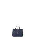 Blue quilted handbag on a white background