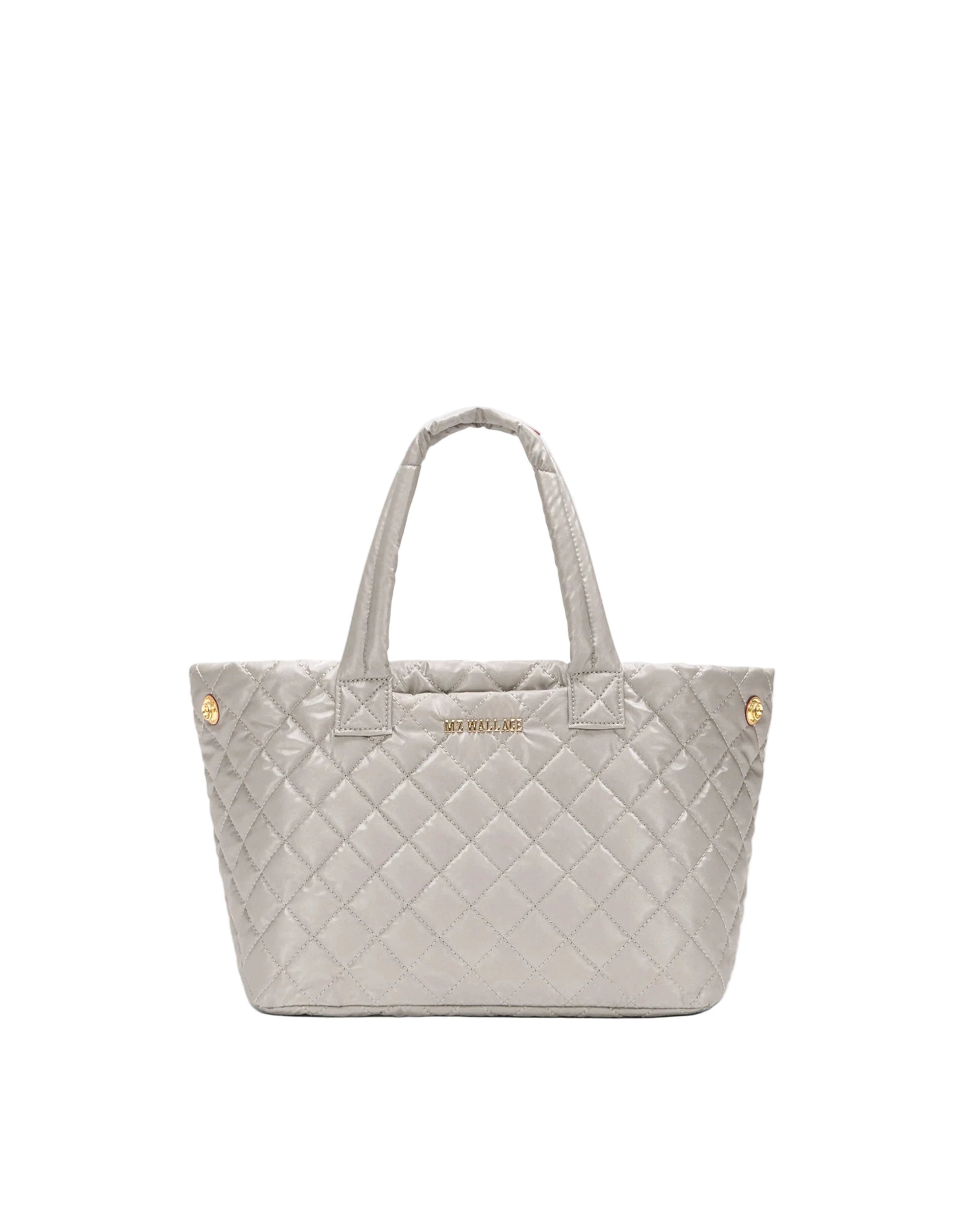 Quilted tote bag with gold accents on a white background