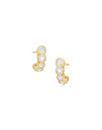 Gold earrings with clear gemstones on a white background