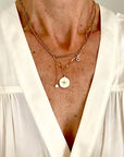 close up of Ma Cocotte Cosmos Necklace on a lady wearing a white v-neck blouse