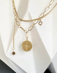 close up of the pendants on the Ma Cocotte Cosmos Necklace on a white background