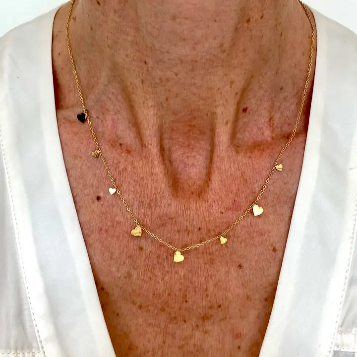 Close up of Ma Cocotte Lola Necklace on a lady's neck wearing a white v-neck blouse