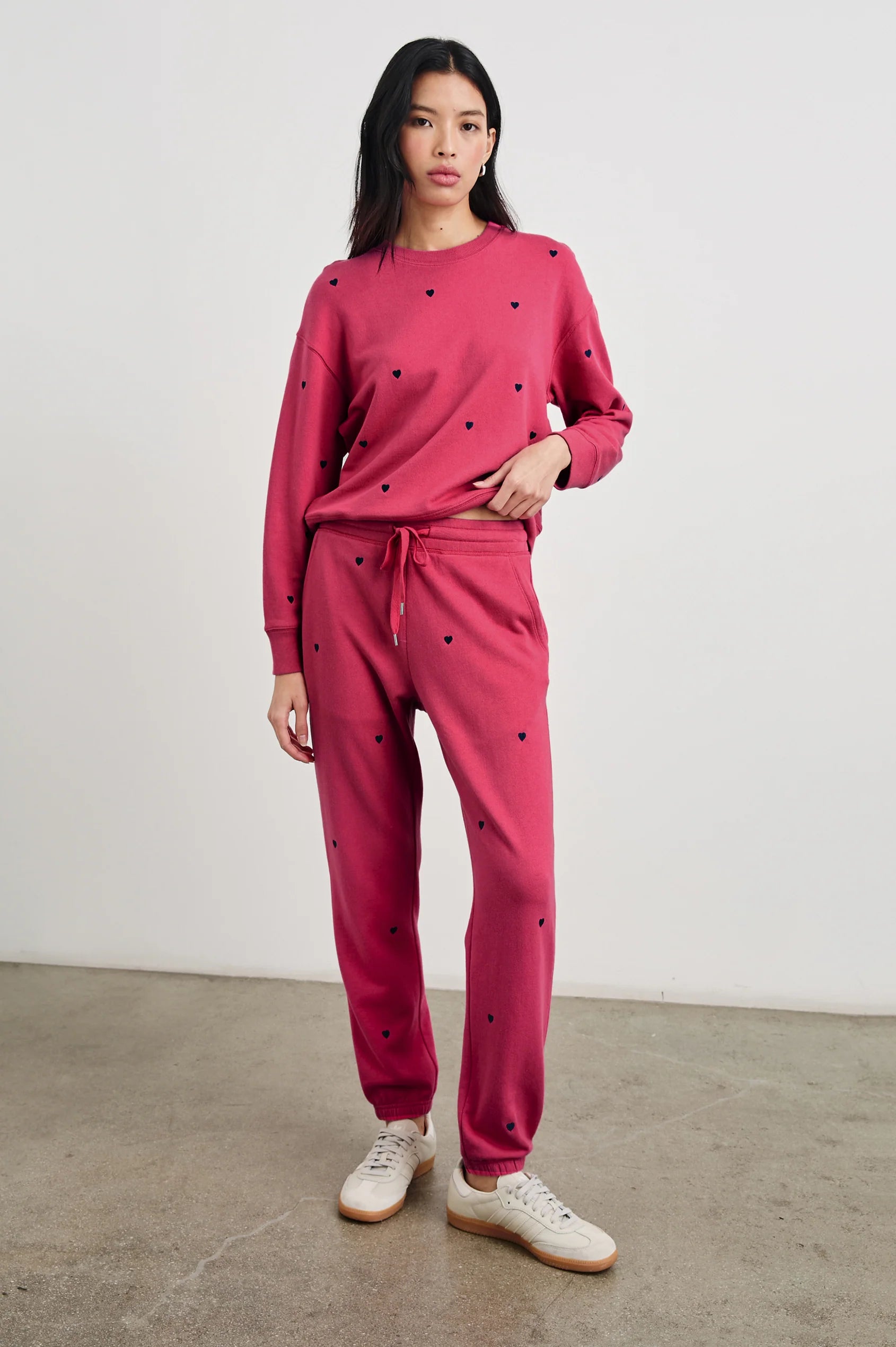 full front view of brunette model with the rails ramona sweatshirt in pink midnight hearts with matching kingston pants