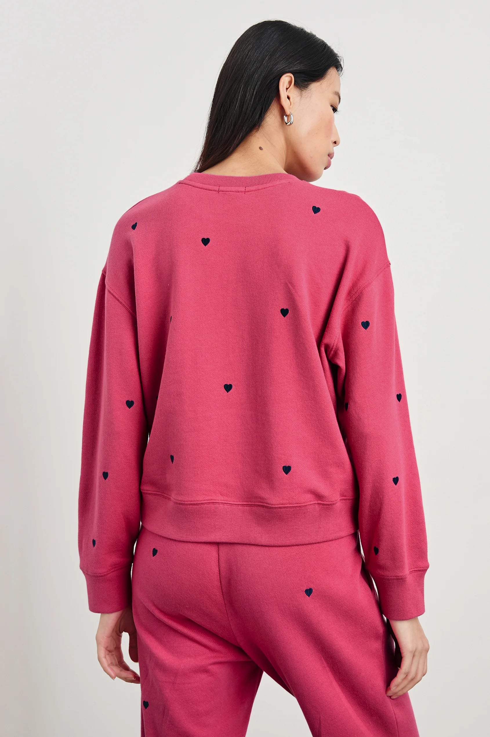 upper half back view of brunette model with the rails ramona sweatshirt in pink midnight hearts with matching kingston pants