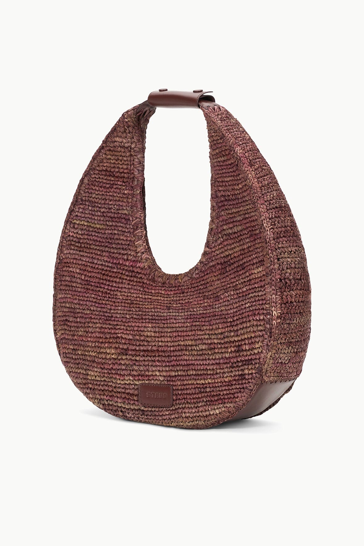 side view of Staud Large Raffia Moon Tote Bag in Mahogany with white background