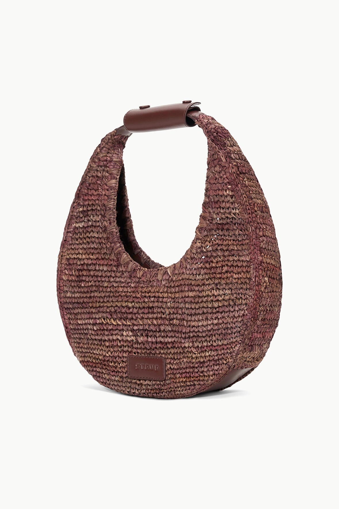 side view of staud moon raffia tote bag in mahogany with white background