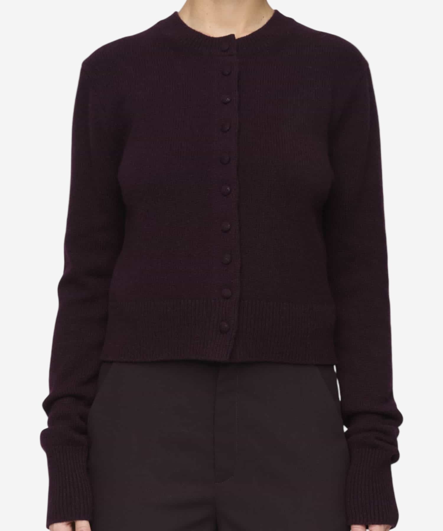 Dark purple cardigan worn by a person on a white background