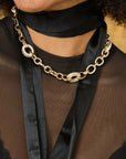 close up of girl in a black top wearing the jane win embellished chunky link chain