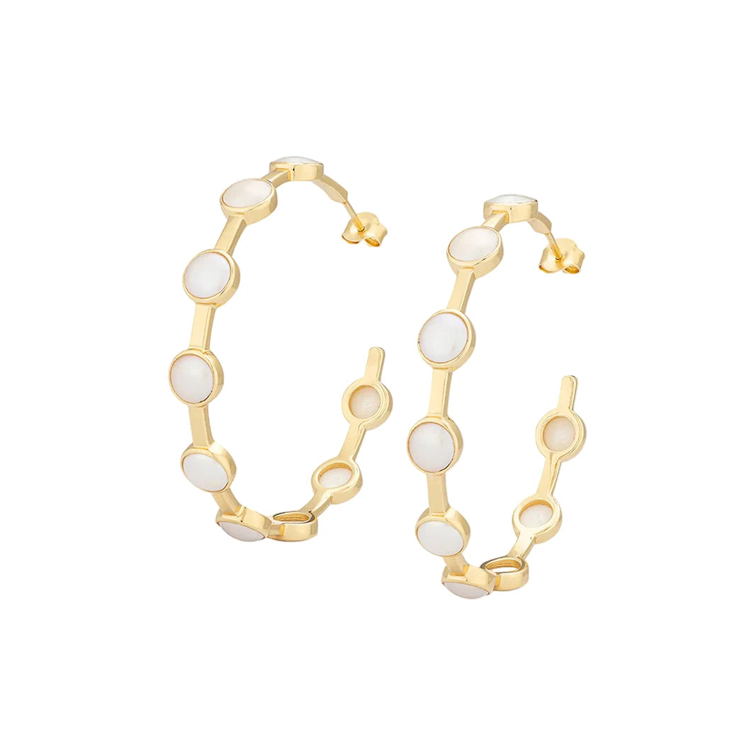 Gold hoop earrings with white stones on a white background