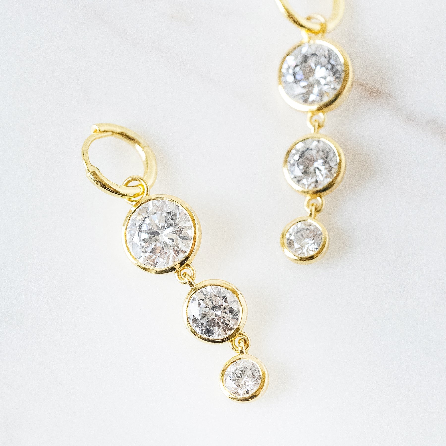 Mini Dropping Circles Huggie Hoop Earrings Cubic Zirconia Earrings Laura Foote Designs 