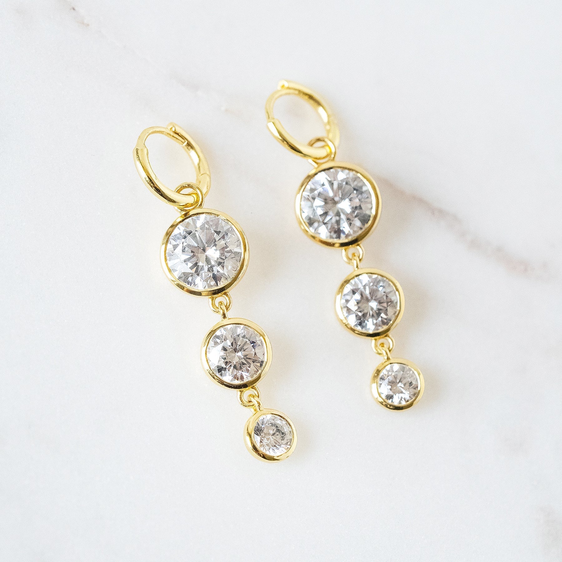 Mini Dropping Circles Huggie Hoop Earrings Cubic Zirconia Earrings Laura Foote Designs 