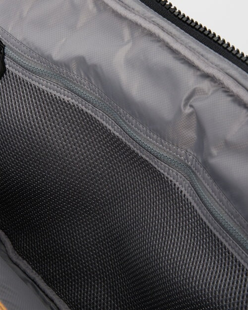 Interior of MZ Wallace Metro Organizer Black Cosmetic mesh zipper pocket with white background. 