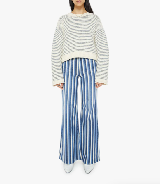 full front view of brunette girl wearing mother bell sleeve jumper roll in did you make that on a white background with striped blue pants