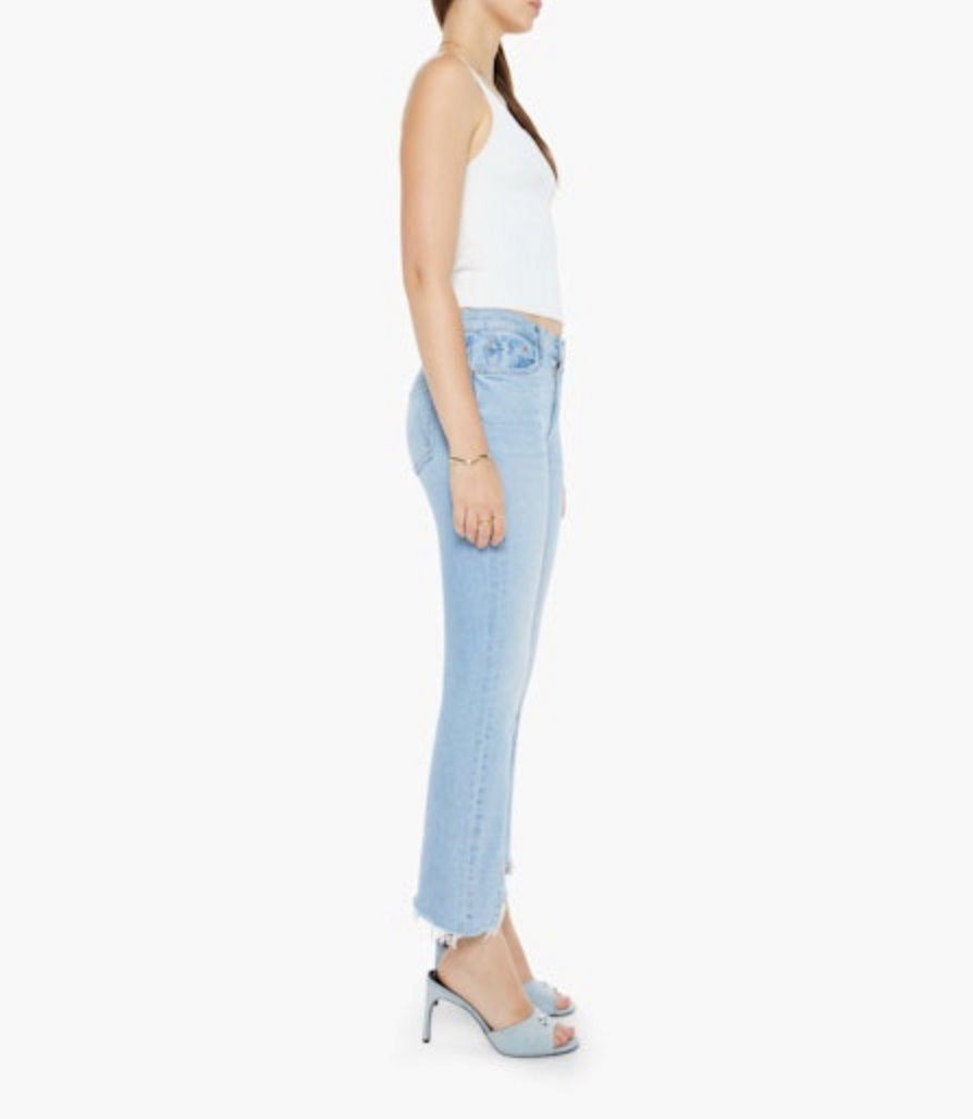 full side view of a model wearing the mother The Insider Crop Pointy Fray Let's Get It Together with a white tank and blue sandals in front of a white background