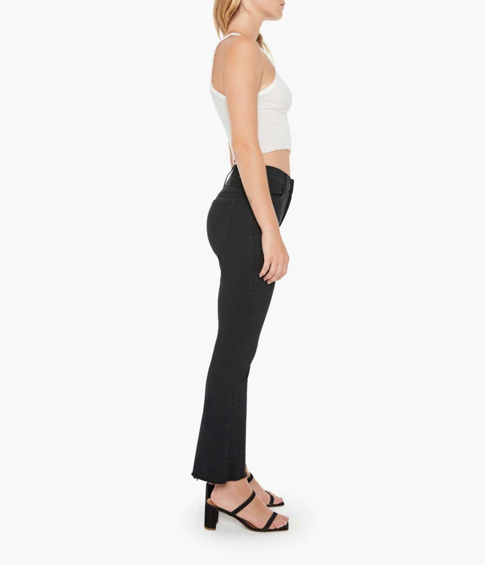 full side view of model wearing the mother Lil Hustler Ankle Fray Not Guilty, a white tank, and black sandals on a white background 