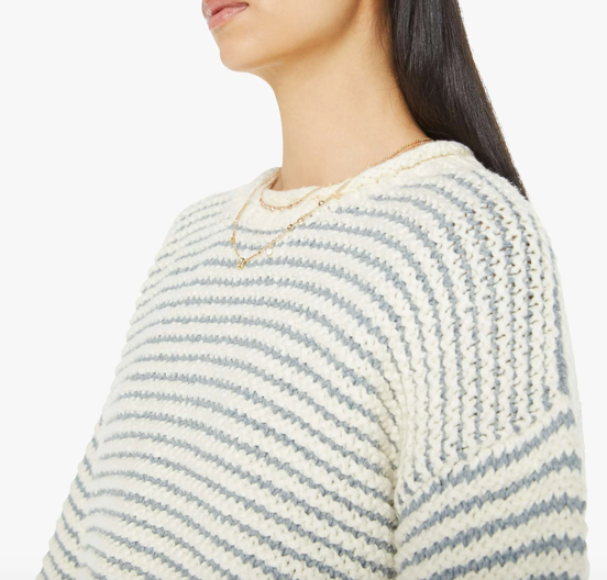 close up view of chest of the sweater on a brunette girl wearing mother bell sleeve jumper roll in did you make that on a white background with striped blue pants