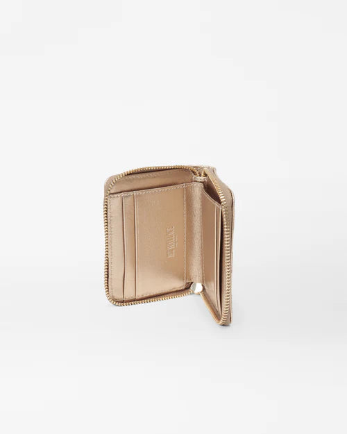 the mz Wallace honey metallic leather small zip round wallet on a white background opened to see the interior