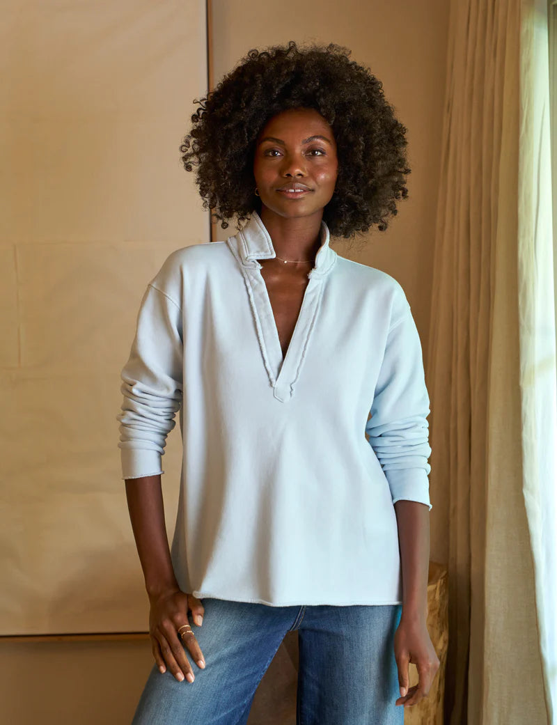 front top half view of a black model wearing the frank & eileen Patrick Popover Henley Triple Fleece Ice and jeans in front of a beige background 