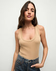 brunette model wearing the Veronica Beard birke tank in khaki and jeans with her hand in her pocket