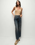 full front view of brunette model wearing the Veronica Beard birke tank in khaki and jeans and tan sneakers with her hand in her pocket