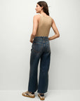 back view of a brunette model wearing the Veronica Beard bike tank in khaki and jeans and tan sneakers