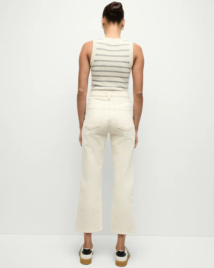 full back view of a model wearing the Veronica Beard ankle high rise straight ecru, a striped tank top, and white sneakers on a white background